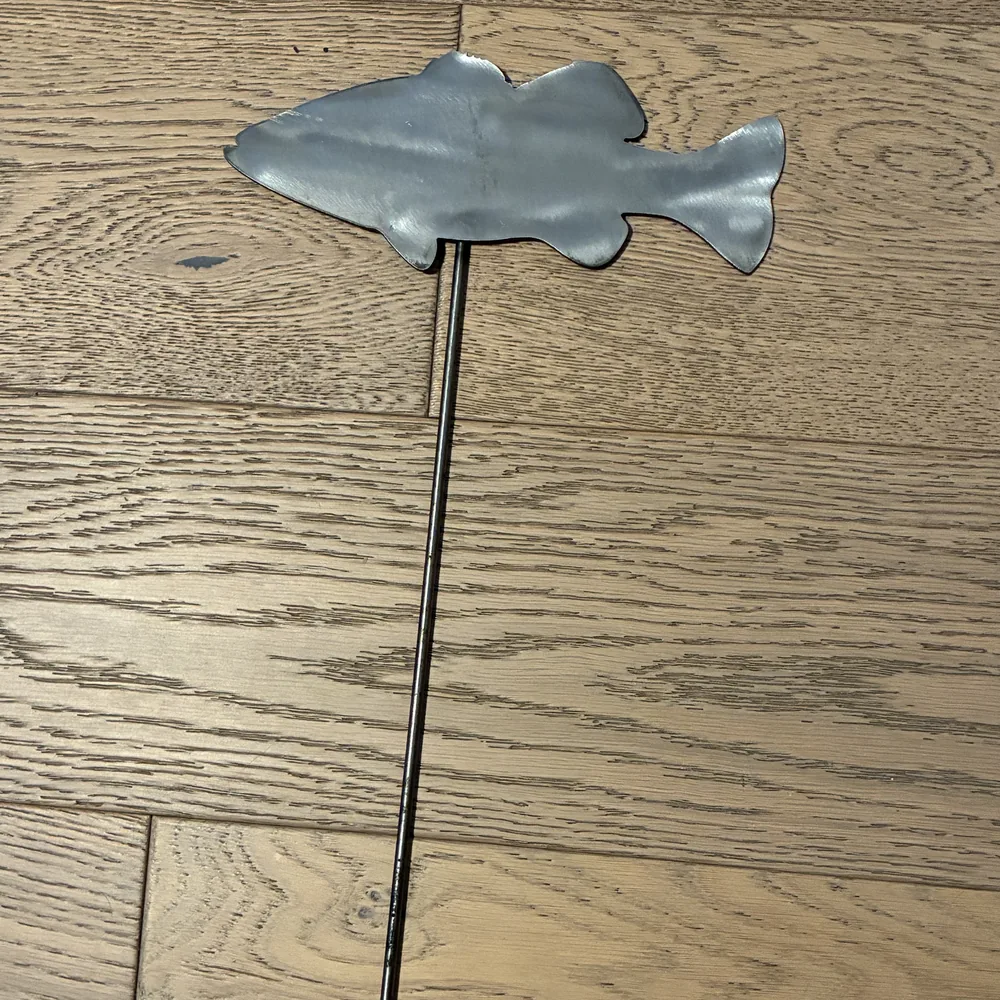 Steel yard stake shaped like a bass.