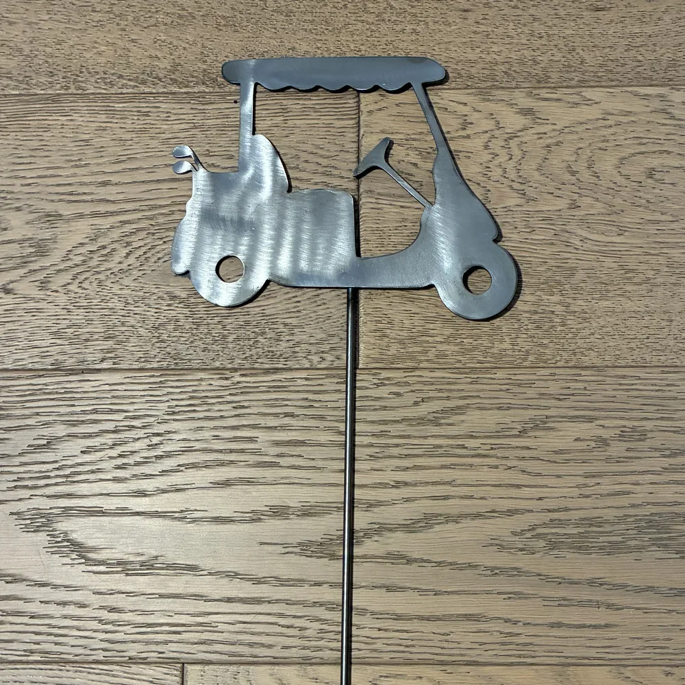Steel yard stake shaped like a golf cart.