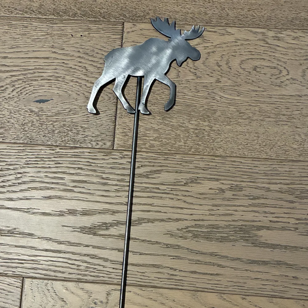 Steel yard stake shaped like a walking moose.