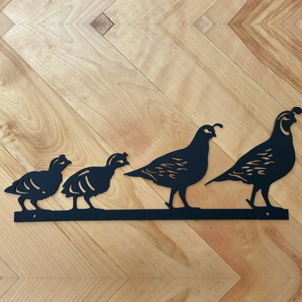 Black steel sign with a family of four quail.