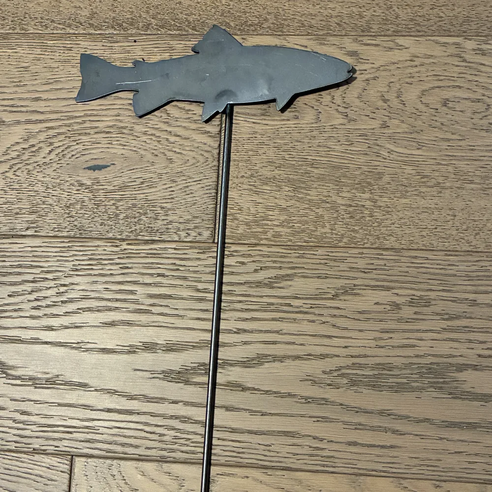 Steel yard stake shaped like a trout.